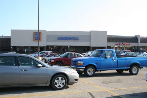 Goodwill store exterior, one-story brick and stucco building in a shopping center.