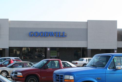 Goodwill store exterior, one-story brick and stucco building in a shopping center.