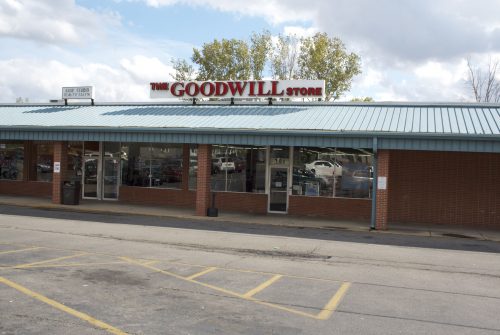 Goodwill store exterior, located in a shopping center, one-story brick building